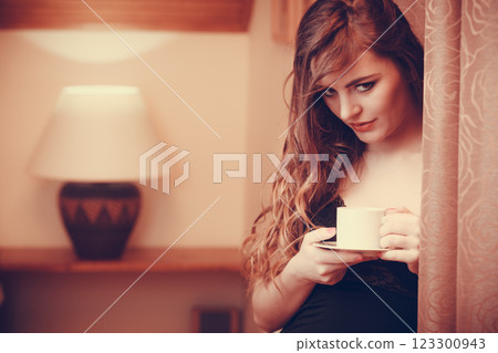 Woman relaxing drinking coffee beverage at home Woman relaxing drinking coffee beverage at home 123300943
