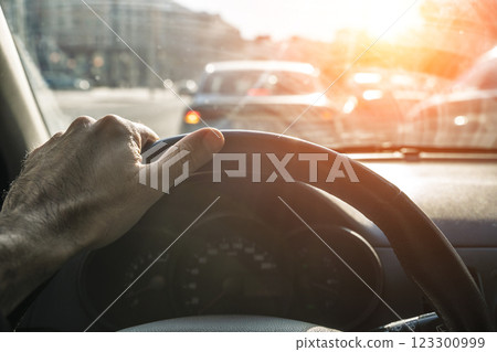 Car dashboard with driver hand on road. Driving car Car dashboard with driver hand on road. Driving car 123300999