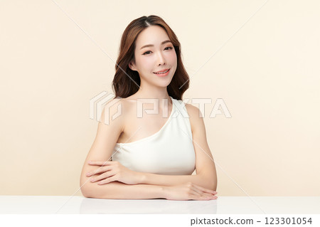 Beautiful young asian woman with clean fresh skin on beige background, Face care, Facial treatment, Cosmetology, beauty and spa, Asian women portrait. Beautiful young asian woman with clean fresh skin on beige background, Face care, Facial treatment, Cosmetology, beauty and spa, Asian women portrait. 123301054
