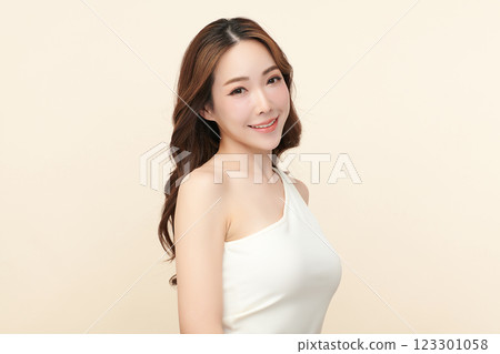 Beautiful young asian woman with clean fresh skin on beige background, Face care, Facial treatment, Cosmetology, beauty and spa, Asian women portrait. 123301058