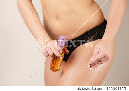 Woman applying moisturizing body oil lotion Woman applying moisturizing body oil lotion 123301155