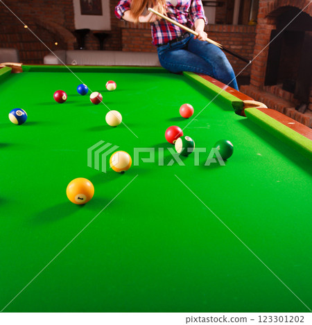 Young fashionable girl playing billiard. Young fashionable girl playing billiard. 123301202