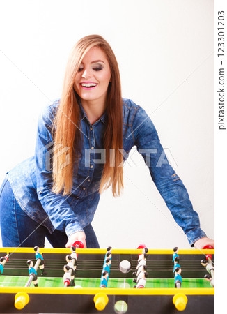 woman playing table football game woman playing table football game 123301203