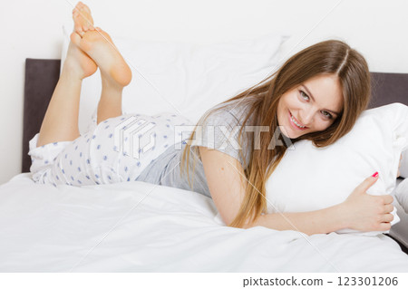 Cheerful girl rolling in bed. 123301206