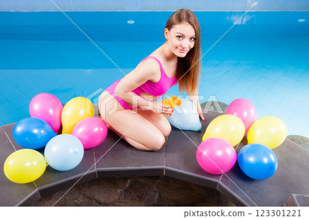 Woman with balloons and cocktail drink at swimming pool. 123301221