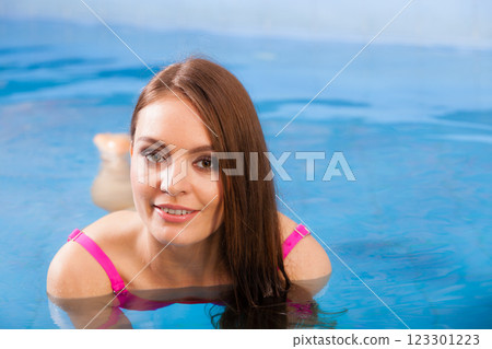 woman enjoying the water in swimming pool woman enjoying the water in swimming pool 123301223