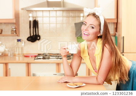 Girl with gingerbread cookies drinking tea coffee. 123301236