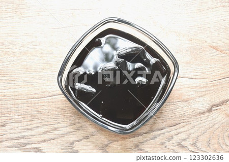 black grass jelly Chinese cold sweetmeat in syrub in glass bowl black grass jelly Chinese cold sweetmeat in syrub in glass bowl 123302636