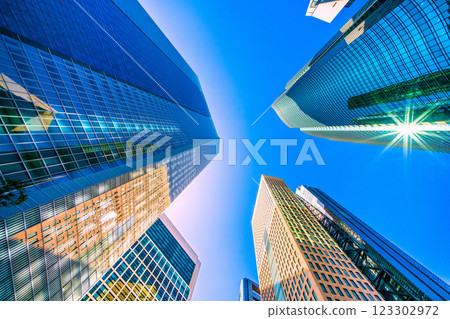 Tokyo cityscape in Japan: A kaleidoscope of rare sights. Bathed in strong light, the Shiodome Tower is clearly reflected on the surrounding buildings... 123302972