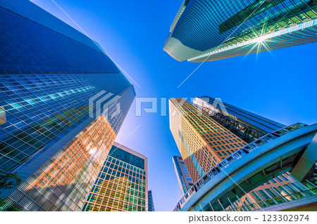 Tokyo cityscape in Japan: A kaleidoscope of rare sights. Bathed in strong light, the Shiodome Tower is clearly reflected on the surrounding buildings... 123302974