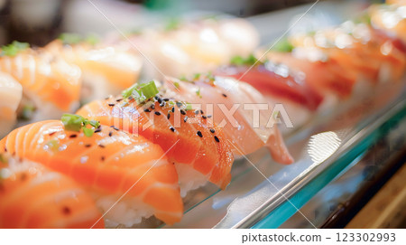 Delight in vibrant colors and exquisite presentation of sushi, featuring fresh slices of salmon, tuna, and other seafood garnished with green onions and sesame seeds 123302993