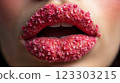 Close-up of beautiful aesthetic lips with red lipstick filled with decorative flowers, sexy and sensual atmosphere 123303215