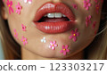 Close-up of beautiful aesthetic lips with red lipstick filled with decorative flowers around, sexy and sensual 123303217