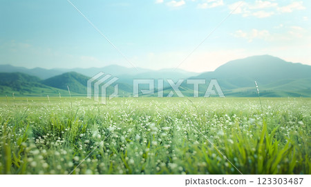 A serene outdoor summer peaceful refreshing greenery landscape field of blooming flowers wildflowers lush green grass on mountains soft sunlight, gentle breeze carries sense of tranquility and joy 123303487