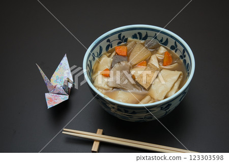 Enjoy warm Himokawa Udon noodles stewed with root vegetables during the cold winter. Enjoy warm Himokawa Udon noodles stewed with root vegetables during the cold winter. 123303598