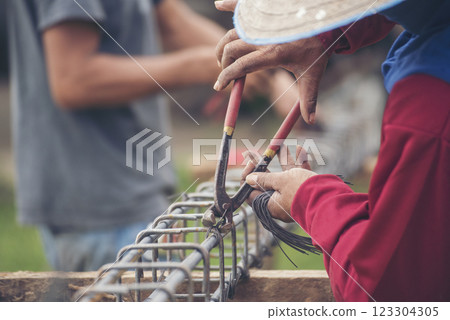 Construction Men hands bending cutting steel wire fences bar reinforcement of concrete work. Worker hands using pincer pliers iron wire. Outdoor Worker using wire bending pliers, construction work Construction Men hands bending cutting steel wire fences bar reinforcement of concrete work. Worker hands using pincer pliers iron wire. Outdoor Worker using wire bending pliers, construction work 123304305