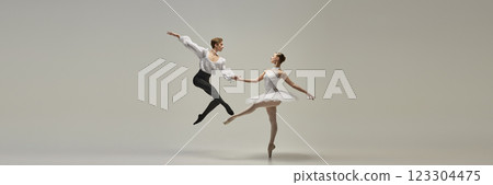 Banner. Ballet duet, young man and woman, dressed elegantly, performing classical dance moves, shows technique and synergy against white background. Banner. Ballet duet, young man and woman, dressed elegantly, performing classical dance moves, shows technique and synergy against white background. 123304475