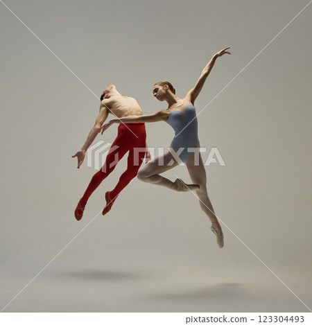 Elegant ballet moment captured mid-movement, highlighting form, control, and expressive artistry against white studio background. Concept of ballet and art Elegant ballet moment captured mid-movement, highlighting form, control, and expressive artistry against white studio background. Concept of ballet and art 123304493