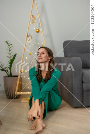 Christmas Tree Woman Green Dress Home Festive Season: Indoor Portrait, December, Peaceful Mood. Christmas Tree Woman Green Dress Home Festive Season: Indoor Portrait, December, Peaceful Mood. 123304504