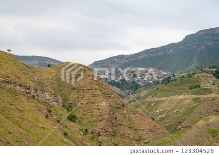 A mountain range with a small town in the valley A mountain range with a small town in the valley 123304528
