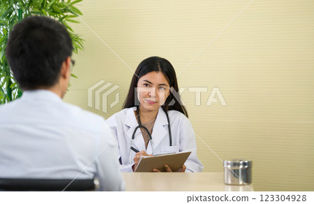 Female doctor meeting with a patient in the office, she is giving a prescription to the man, healthcare and medicine concept 123304928