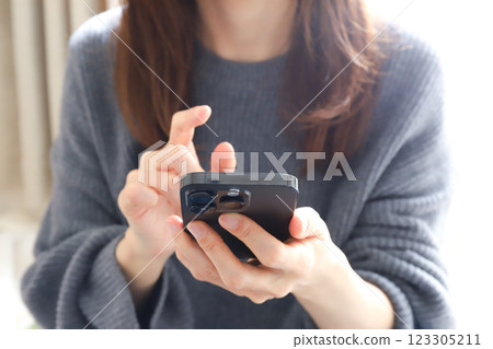 A woman using a smartphone A woman using a smartphone 123305211