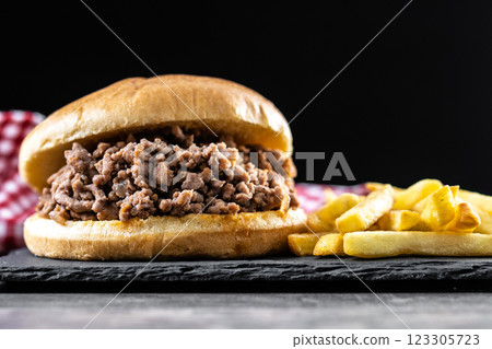Traditional sloppy joe sandwich with french fries on wooden table Traditional sloppy joe sandwich with french fries on wooden table 123305723