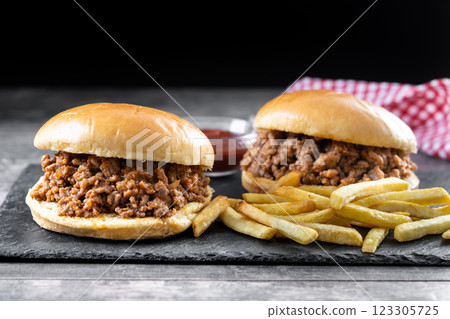 Traditional sloppy joe sandwich with french fries on wooden table Traditional sloppy joe sandwich with french fries on wooden table 123305725