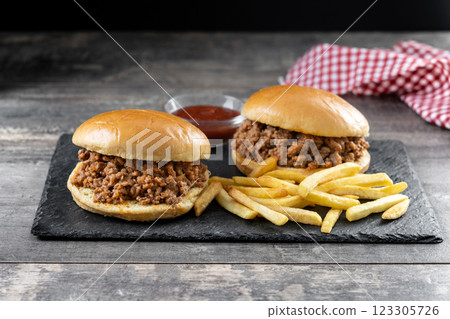 Traditional sloppy joe sandwich with french fries on wooden table 123305726