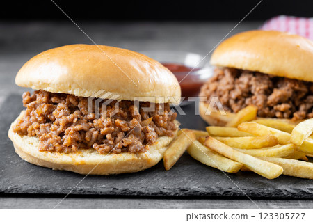 Traditional sloppy joe sandwich with french fries on wooden table 123305727