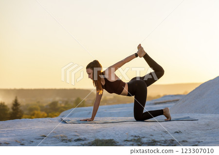 Yoga practice at sunset on a mountain with a serene atmosphere 123307010