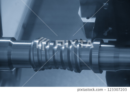 The  CNC lathe machine forming  cutting the metal  screw shaft parts in the light blue scene. 123307203