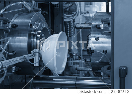 The plastic blow parts from injection machine gripped by vacuum robotic system. The plastic blow parts from injection machine gripped by vacuum robotic system. 123307210