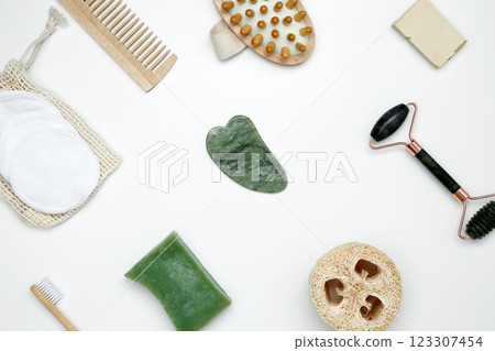 Eco-friendly beauty essentials, including soap, bamboo toothbrush, loofah sponge, marble face roller, embodying a sustainable self-care concept Eco-friendly beauty essentials, including soap, bamboo toothbrush, loofah sponge, marble face roller, embodying a sustainable self-care concept 123307454