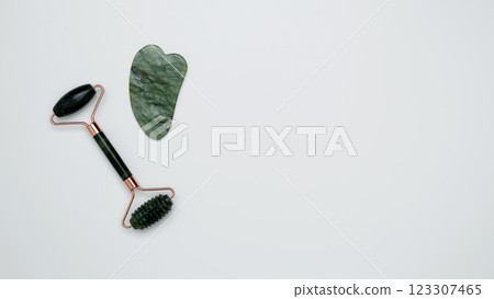 Green marble face roller and gua sha tool emphasizing simplicity Green marble face roller and gua sha tool emphasizing simplicity 123307465