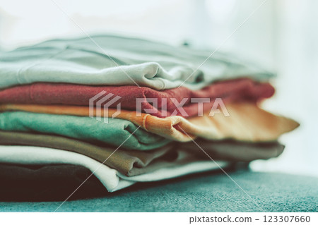 Colorful Stacked Clothing on a Surface in Soft Light Colorful Stacked Clothing on a Surface in Soft Light 123307660