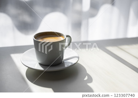 A cup of espresso placed near a sunlit window A cup of espresso placed near a sunlit window 123307740