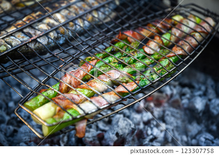 Grilling green asparagus with bacon on grill Grilling green asparagus with bacon on grill 123307758