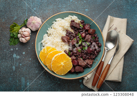 Feijoada, traditional brazilian stew with black beans, rice, and orange slices, top view 123308048