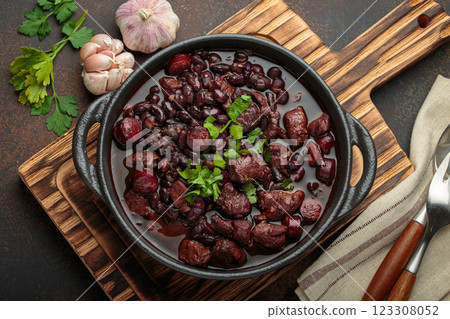 Brazilian feijoada with black beans, sausage, and meat in a pot, top view Brazilian feijoada with black beans, sausage, and meat in a pot, top view 123308052