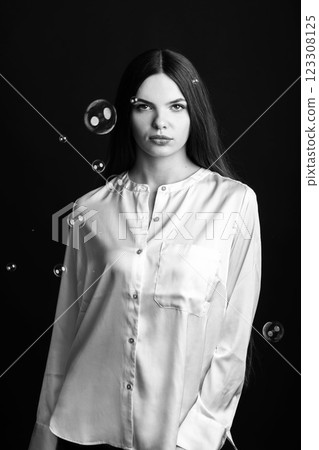 Beautiful woman with soap bubbles studio portrait Beautiful woman with soap bubbles studio portrait 123308125
