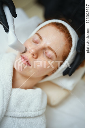 Skincare treatment session at a wellness center with a relaxed client 123308617