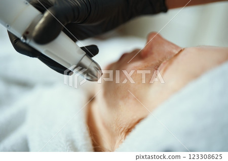 Professional skin treatment process in a cosmetic clinic for facial rejuvenation Professional skin treatment process in a cosmetic clinic for facial rejuvenation 123308625