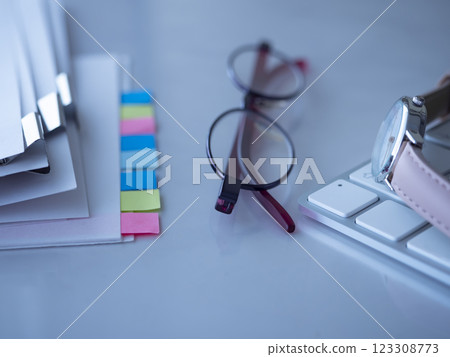 Documents, keyboard, glasses and watch on the table 123308773
