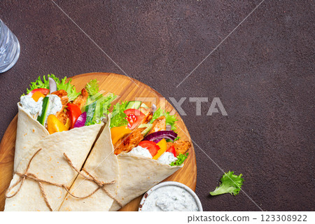 Greek chicken souvlaki wraps with vegetables 123308922
