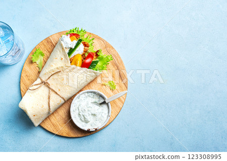 Greek chicken souvlaki or gyro wrap 123308995