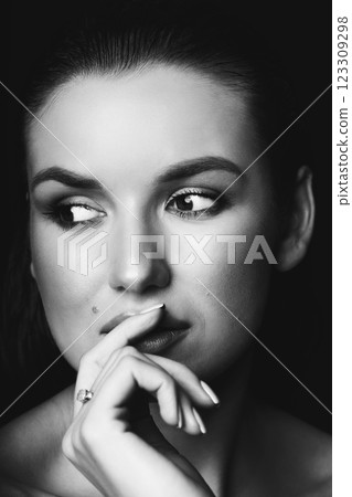 Beautiful woman with dark hair and blouse close-up studio portrait 123309298