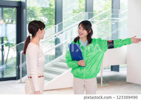 Event staff guiding customers with a smile Event staff guiding customers with a smile 123309490