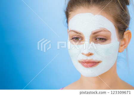 Girl with dry white mud mask on face 123309671