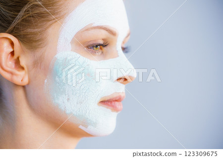 Girl with white green mud mask on face Girl with white green mud mask on face 123309675